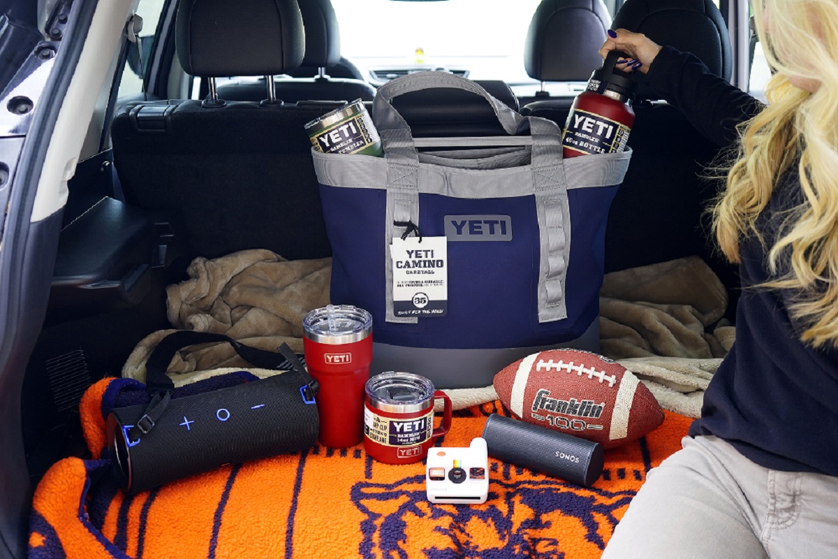 Speakers, a cooler and a football in the trunk of a car