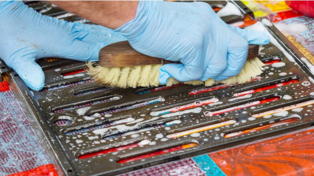 Scrubbing grates with a wire brush