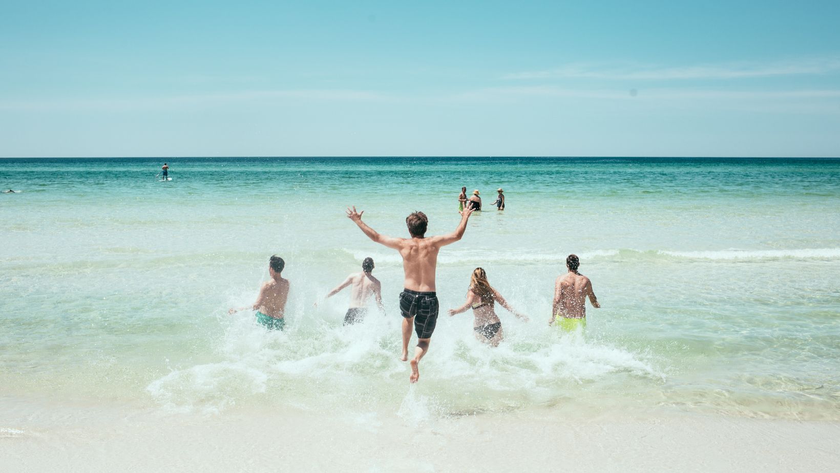 five friends enjoying a beach day in the ocean