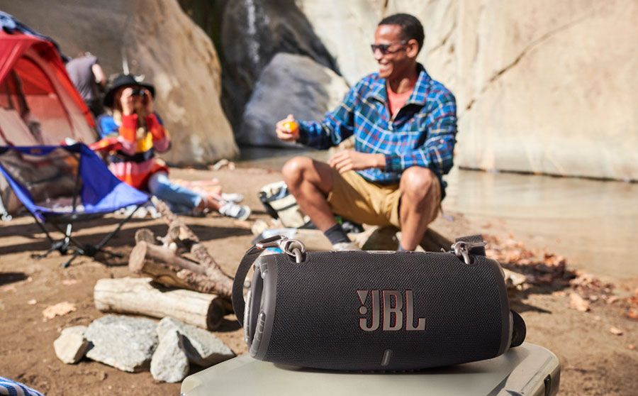 JBL Xtreme 3 Portable Speaker in black with campers on a beach