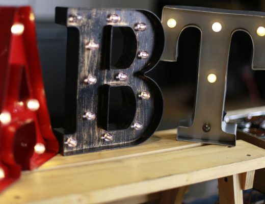 "Abt" spelled out in light-up letters. The A is red, the B is black and the T is grey
