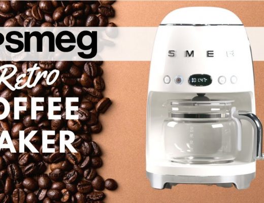 white Smeg coffee maker on a light brown background with an image of coffee beans next to it
