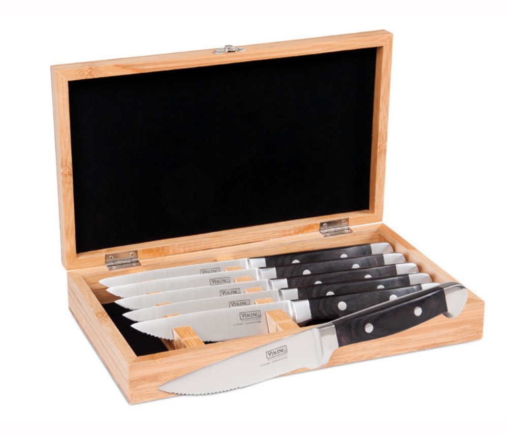 a set of six steak knives with black handles in a wooden storage box lined with black fabric