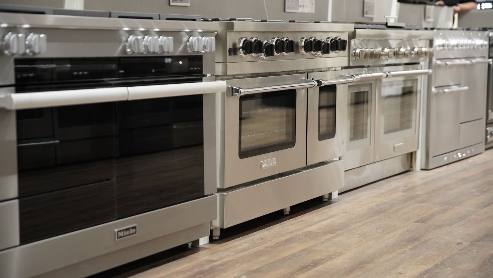 close up of a row of stainless steel kitchen ranges