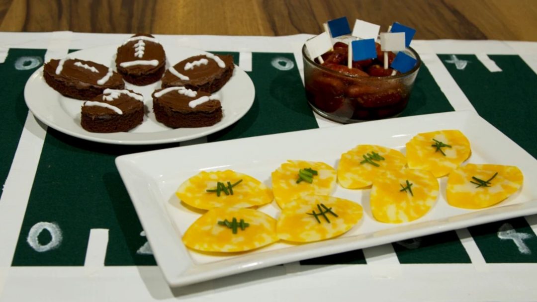 football-shaped snacks on a tablecloth that looks like a football field