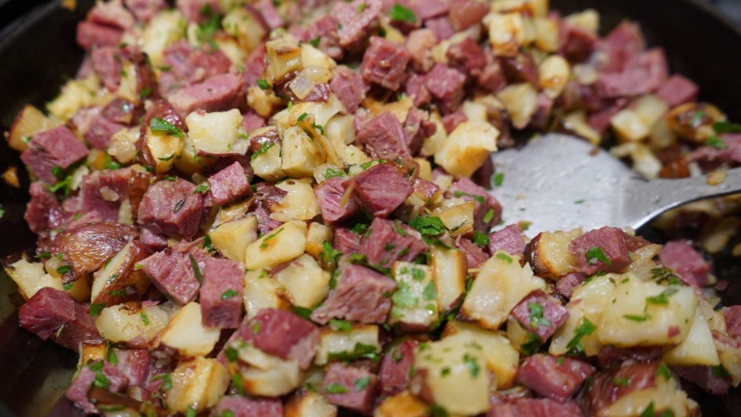 A zoomed-in image of a skillet of corned beef hash