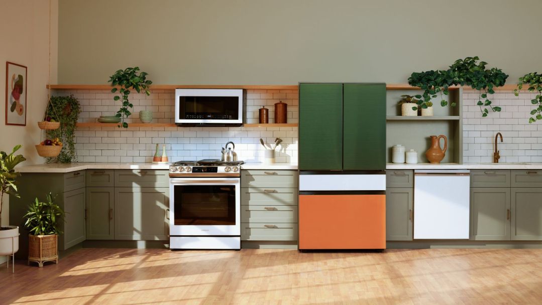 A new kitchen filled with Samsung appliances, mainly showcasing the bespoke french door refrigerator with dark green doors, a white flex bar and an orange freezer door