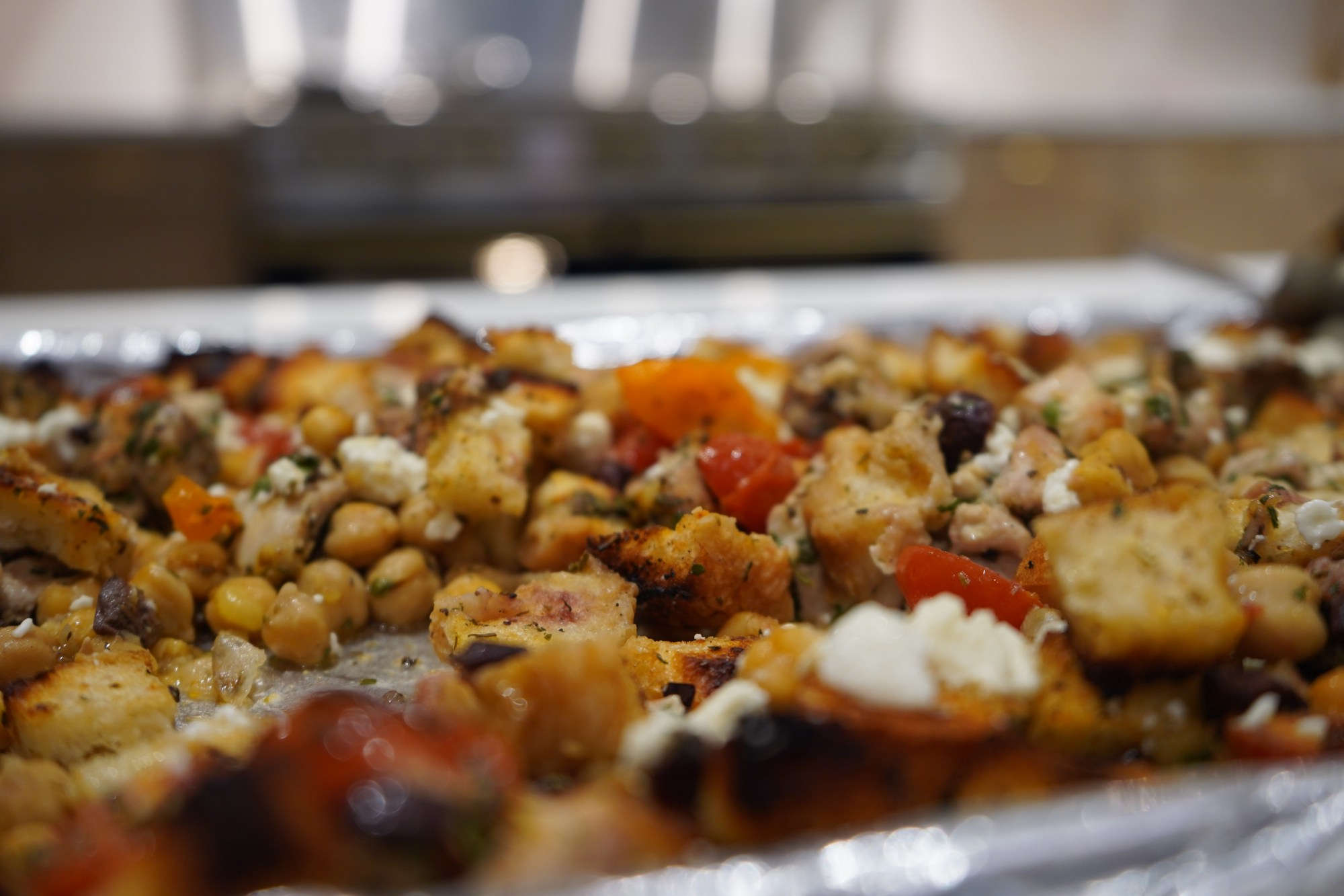 A Tray of Mediterranean-spiced foods: chicken, garbanzo beans and feta.