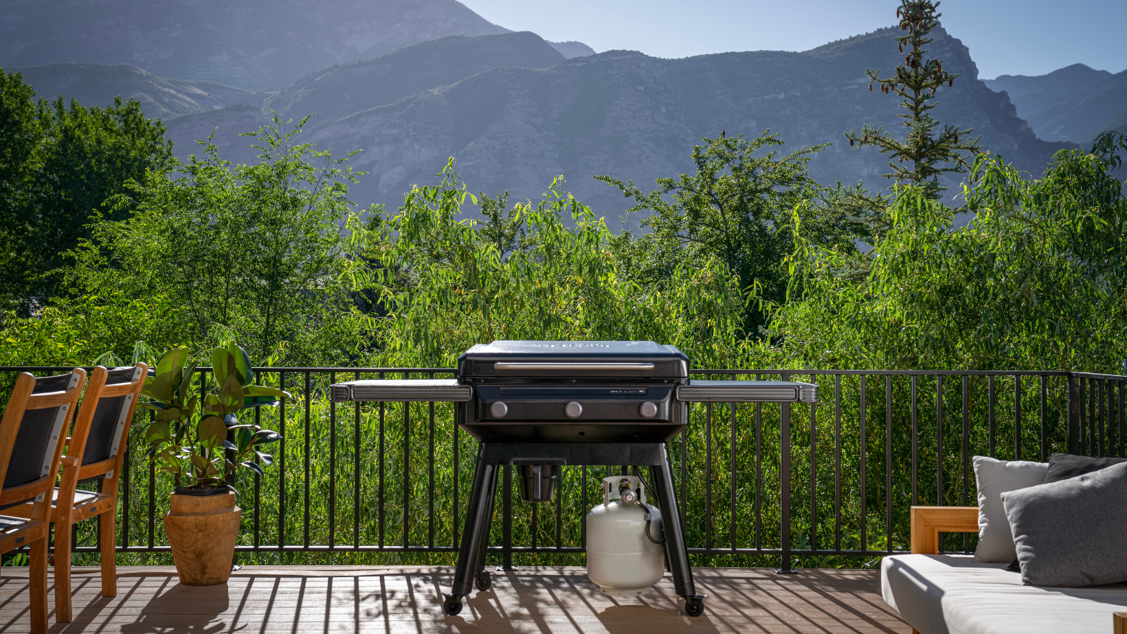 The Traeger Flatrock Griddle on a patio with beautiful mountains in the background.