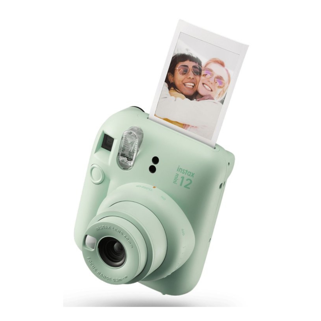 A mint green instant film camera with a photo popping out of the built-in printer