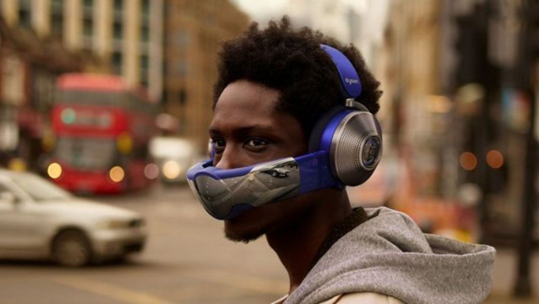 A man in the city using the Dyson Zone headphones including the Visor.