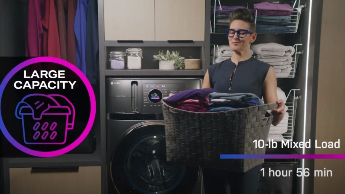 Person in their walk in closet laundry room combo, standing beside their GE combo washer. A graphic mentions the large capacity and time: 10 lb mixed load, and 1 hr 56 minute run time.