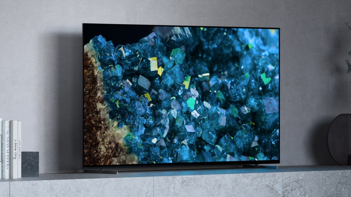 A Sony A80L TV sitting on a grey stone mantel. Onscreen is an image of blue geode crystals.
