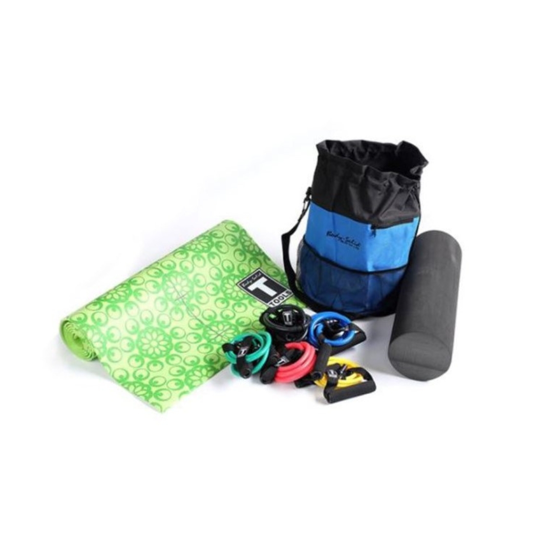 A bag with workout accessories like a green yoga mat, multiple resistance bands and a foam roller