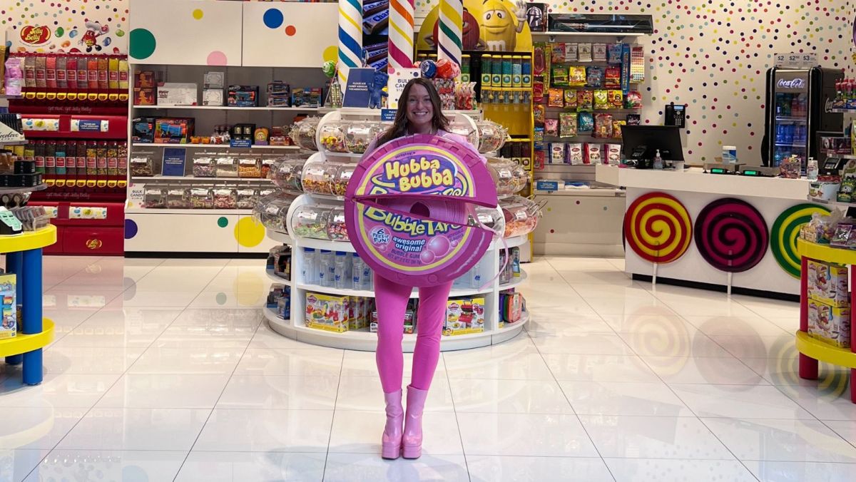 Amanda from the Candy Store dressed for our Costume Contest as a roll of Hubba Bubba Bubble Tape, standing in the Candy Store