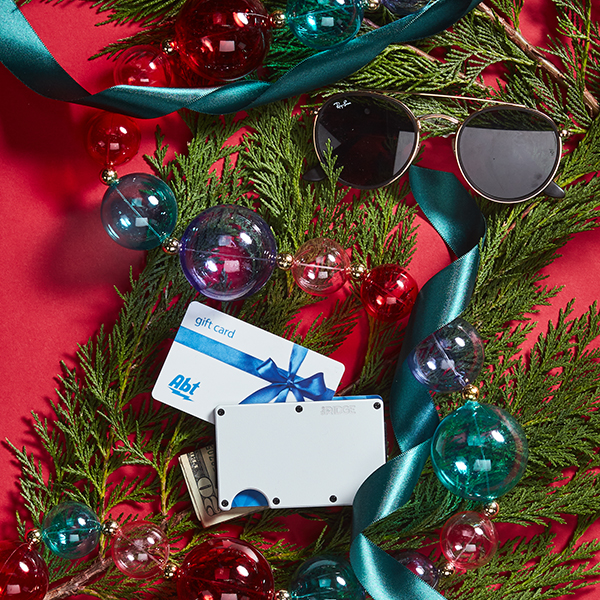 Sunglasses, an RFID wallet and an Abt gift card sitting among holiday decorations