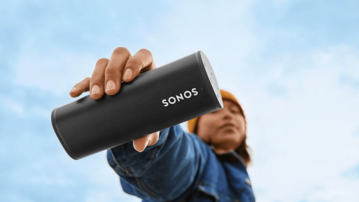 Picture of a person holding the Sonos Roam Smart Speaker.