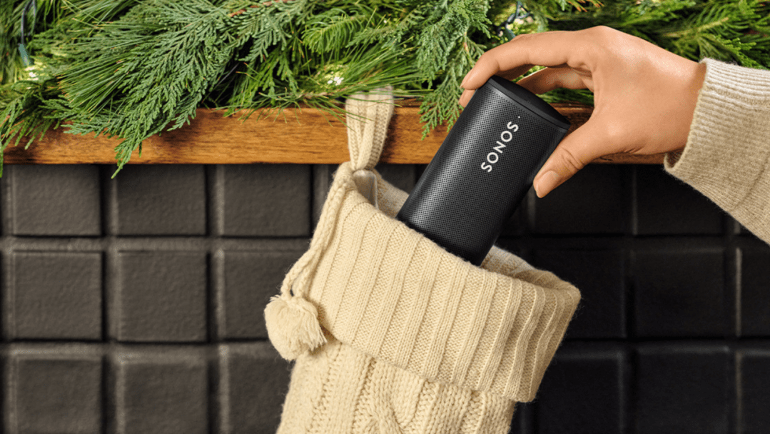 Sonos Roam speaker being placed into a stocking.