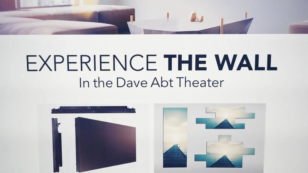 A poster displaying the phrase "Experience The Wall" In the Dave Abt Theater.