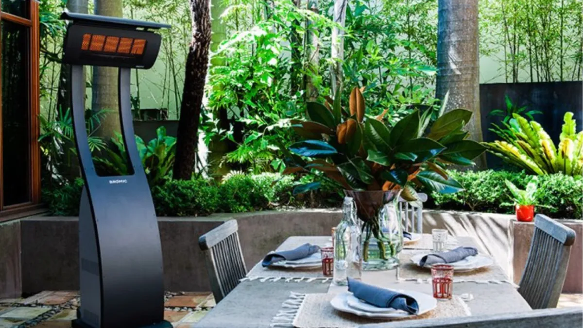 A standing patio heater beside an outdoor dining table