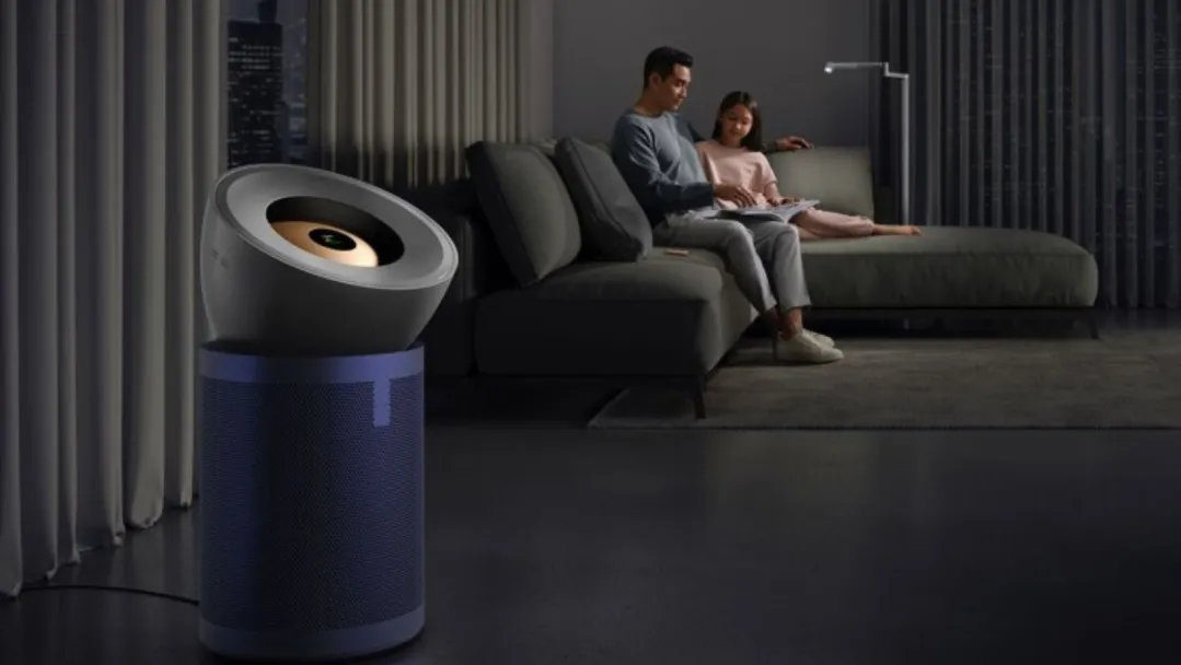 The Dyson BP03 air purifier in a large dark living room with a father and daughter on a distant sofa.