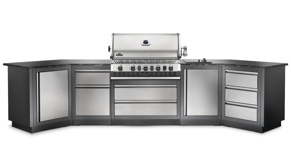 A silver color built-in grill, installed with a full outdoor kitchen set.