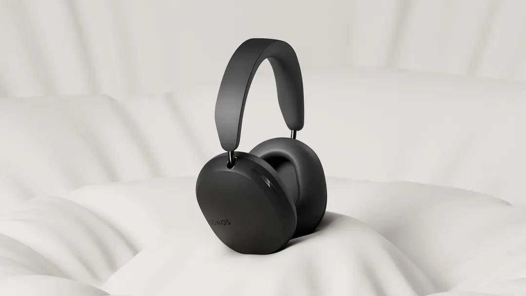 A black pair of headphones, the Sonos Ace, against a white fabric background